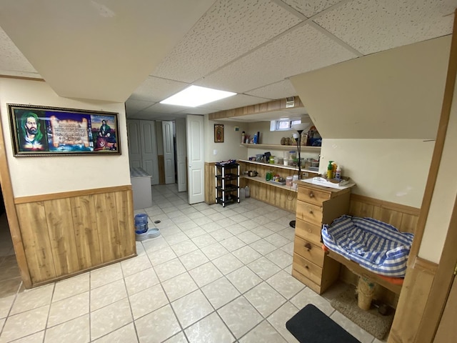 3846 Brummel St, Skokie, IL 60076 - finished below grade area featuring wainscoting, a drop ceiling, wooden walls, and light tile patterned floors