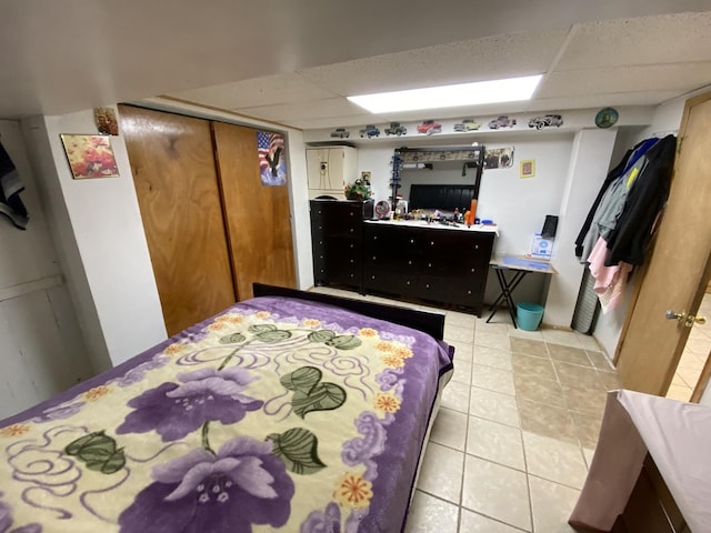 3846 Brummel St, Skokie, IL 60076 - bedroom featuring light tile patterned floors, a drop ceiling, and a closet