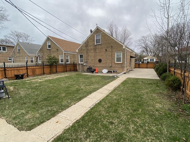 3846 Brummel St, Skokie, IL 60076 - rear view of house with a patio and brick siding