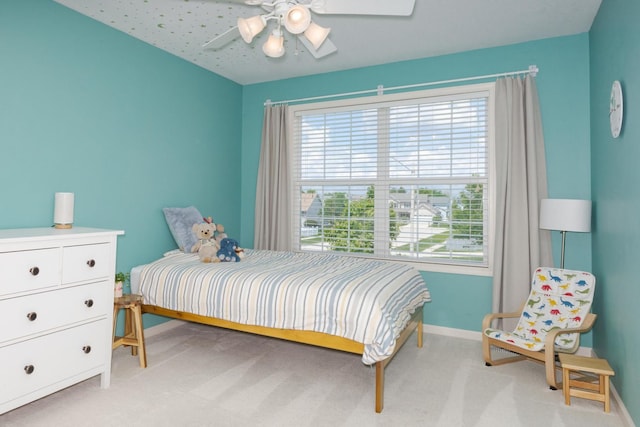 bedroom with baseboards, light carpet, and a ceiling fan
