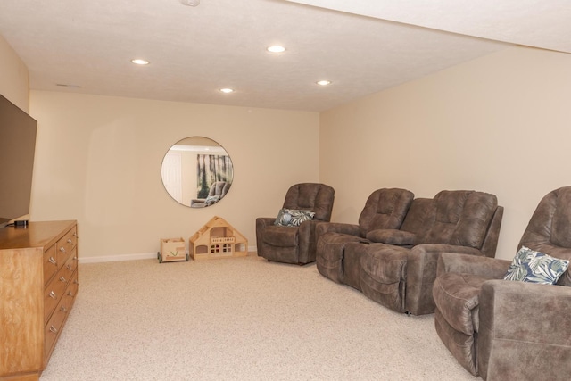 carpeted living area with recessed lighting and baseboards