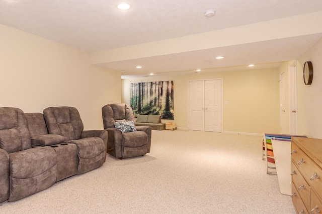 carpeted living room with recessed lighting and baseboards