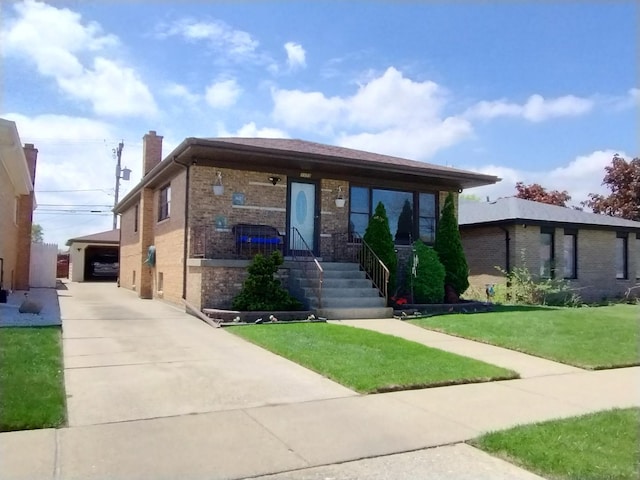 1173 Lucas St, Calumet City, IL 60409 - view of front of home with a chimney, a front yard, brick siding, and an outdoor structure
