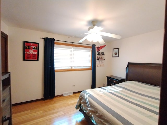 1173 Lucas St, Calumet City, IL 60409 - bedroom with light wood-type flooring, ceiling fan, and baseboards