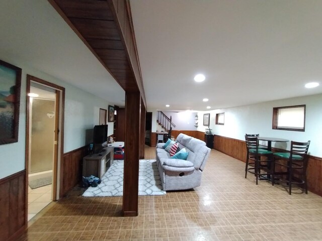1173 Lucas St, Calumet City, IL 60409 - living room featuring a wainscoted wall, stairway, wood walls, recessed lighting, and a bar