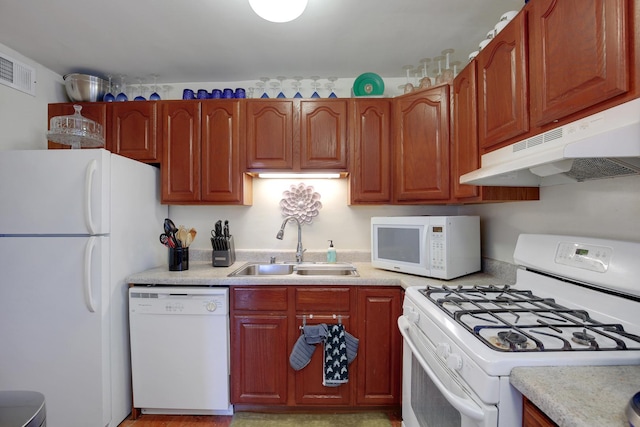 2605 S Indiana Ave Unit 402, Chicago, IL 60616 - kitchen featuring white appliances, under cabinet range hood, a sink, and light countertops