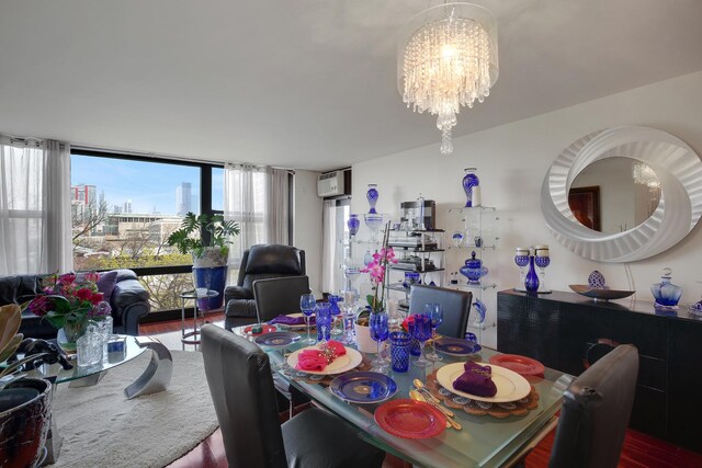 2605 S Indiana Ave Unit 402, Chicago, IL 60616 - dining room with a chandelier, wood finished floors, a wall mounted air conditioner, and floor to ceiling windows
