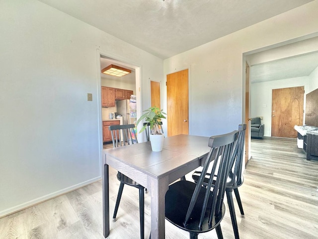 8344 N Milwaukee Ave, Niles, IL 60714 - dining room featuring light wood-style flooring and baseboards