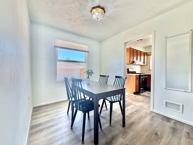 8344 N Milwaukee Ave, Niles, IL 60714 - dining space with light wood-style flooring and baseboards