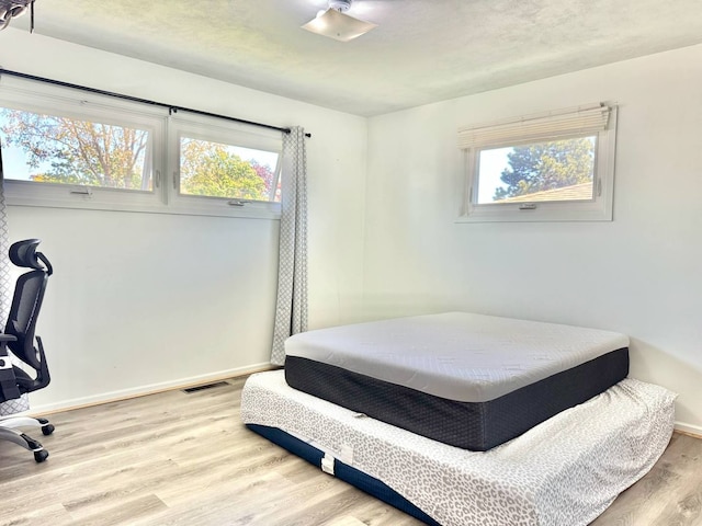 8344 N Milwaukee Ave, Niles, IL 60714 - bedroom featuring light wood finished floors and baseboards