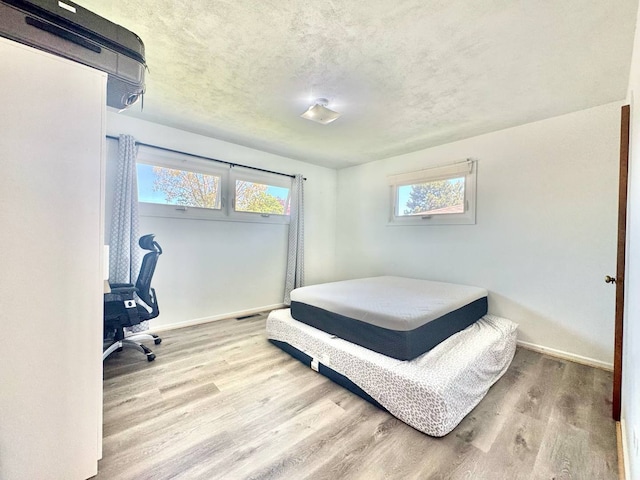 8344 N Milwaukee Ave, Niles, IL 60714 - bedroom featuring wood finished floors, baseboards, and an office area