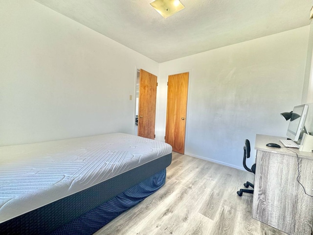 8344 N Milwaukee Ave, Niles, IL 60714 - bedroom featuring wood finished floors, an office area, and baseboards