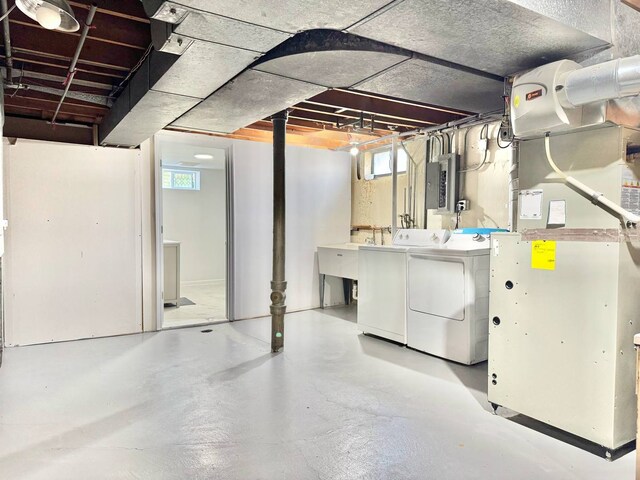 8344 N Milwaukee Ave, Niles, IL 60714 - below grade area with independent washer and dryer, heating unit, electric panel, and a sink