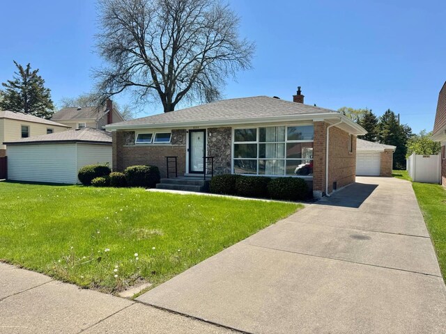 8344 N Milwaukee Ave, Niles, IL 60714 - view of front of property with brick siding, a chimney, a front lawn, a detached garage, and roof with shingles