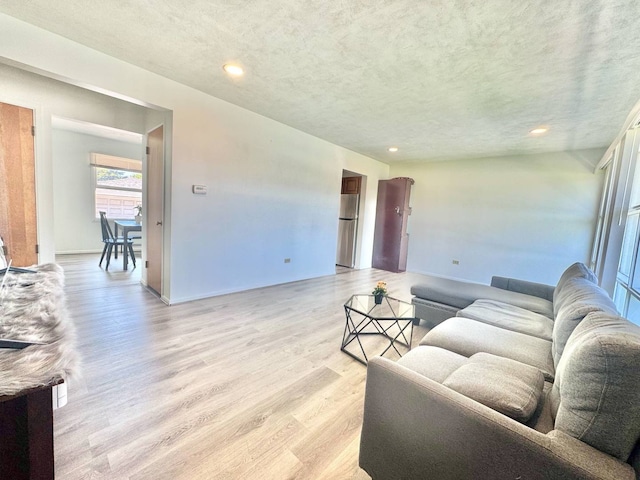 8344 N Milwaukee Ave, Niles, IL 60714 - living room featuring a textured ceiling, light wood-style floors, recessed lighting, and baseboards