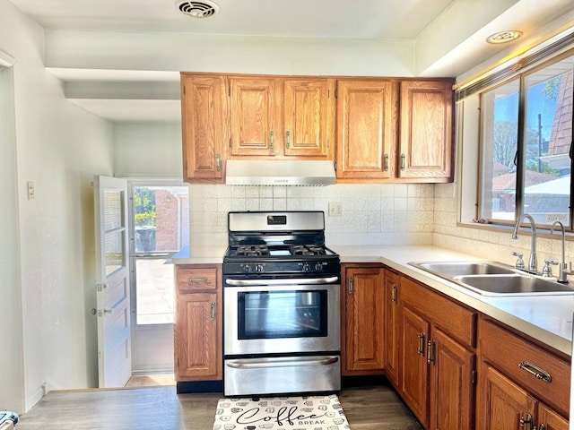 8344 N Milwaukee Ave, Niles, IL 60714 - kitchen with extractor fan, stainless steel gas range, a sink, light countertops, and decorative backsplash