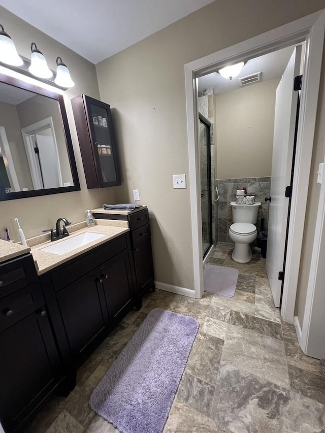 7427 Mccurry Rd, Roscoe, IL 61073 - full bathroom with toilet, a shower stall, vanity, and tile walls
