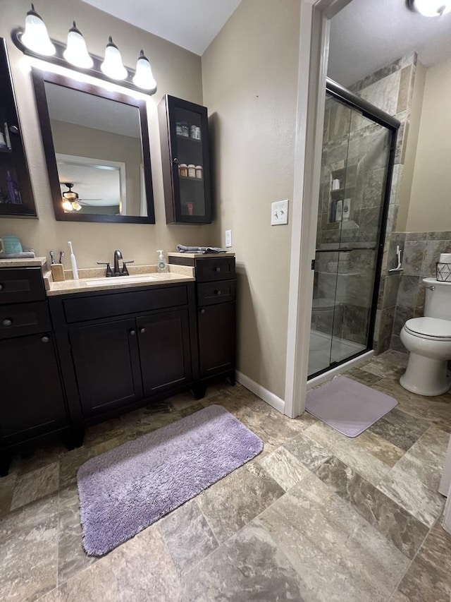 7427 Mccurry Rd, Roscoe, IL 61073 - full bath with a shower stall, stone finish flooring, vanity, toilet, and baseboards