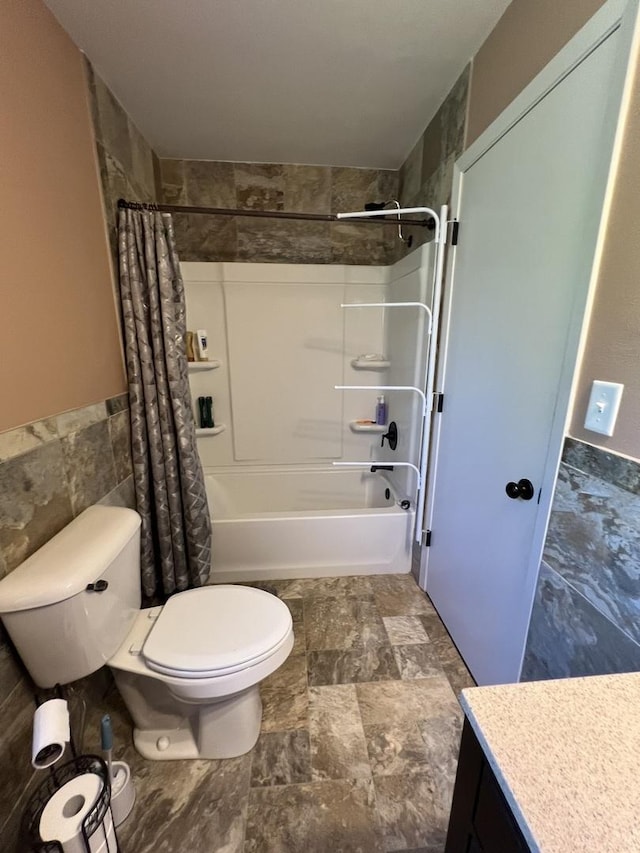 7427 Mccurry Rd, Roscoe, IL 61073 - full bathroom featuring tile walls, toilet, shower / bathtub combination with curtain, vanity, and wainscoting