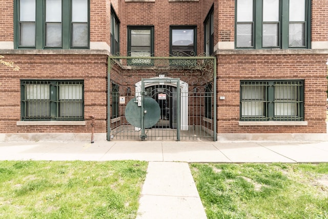 4639 S Saint Lawrence Ave Unit 2, Chicago, IL 60653 - view of exterior entry with a gate, fence, and brick siding