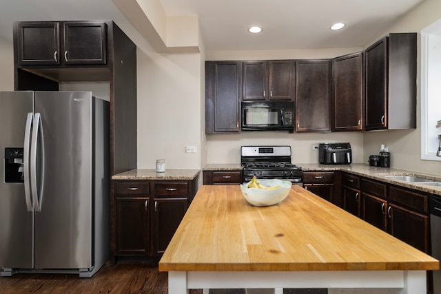 4639 S Saint Lawrence Ave Unit 2, Chicago, IL 60653 - kitchen featuring appliances with stainless steel finishes, butcher block countertops, dark wood-style floors, dark brown cabinets, and recessed lighting