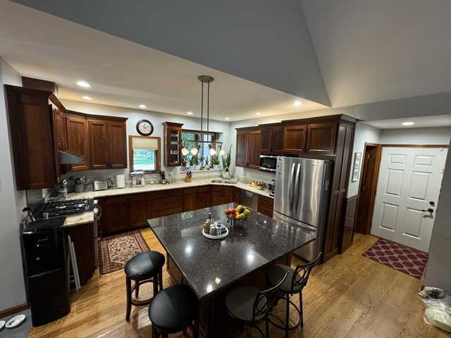 24-114 Lake Carroll Blvd, Lake Carroll, IL 61046 - kitchen featuring stainless steel appliances, light wood-style floors, a kitchen bar, a kitchen island, and recessed lighting