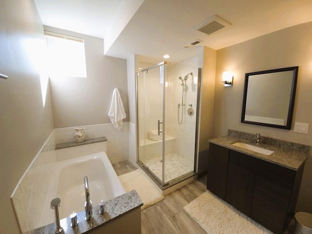 24-114 Lake Carroll Blvd, Lake Carroll, IL 61046 - full bath featuring a shower stall, wood finished floors, a garden tub, and vanity