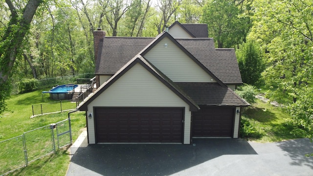 24-114 Lake Carroll Blvd, Lake Carroll, IL 61046 - garage featuring a view of trees