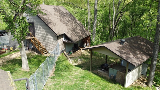 24-114 Lake Carroll Blvd, Lake Carroll, IL 61046 - view of home's exterior with a shingled roof and stairway