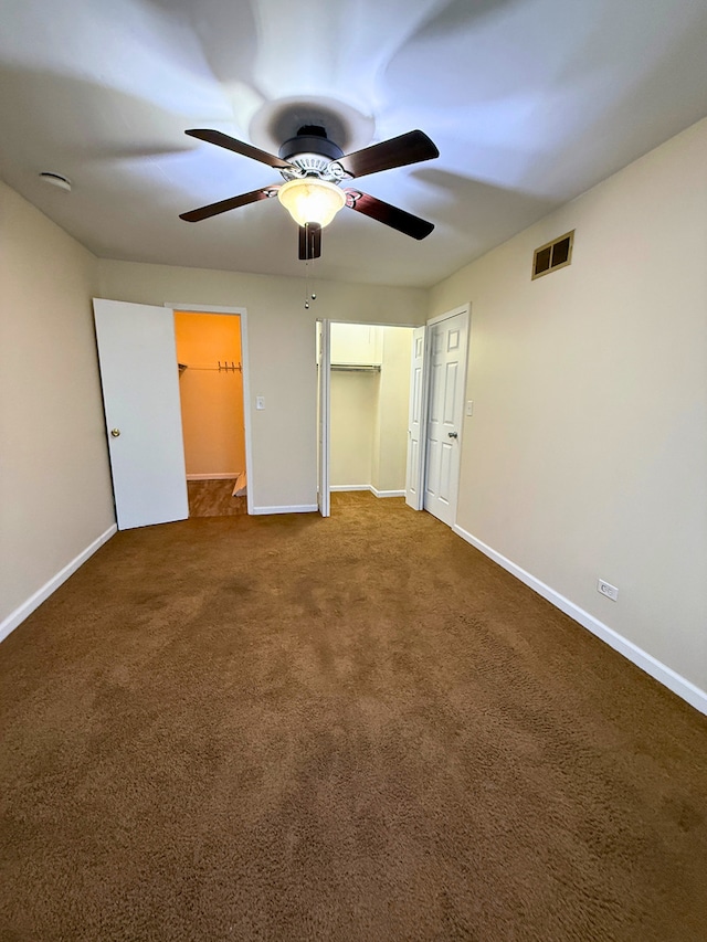 unfurnished bedroom featuring baseboards, carpet floors, a closet, and a ceiling fan
