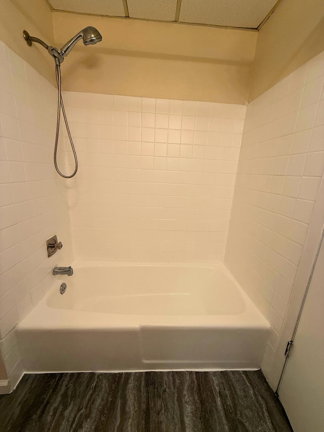 full bathroom featuring wood finished floors and washtub / shower combination
