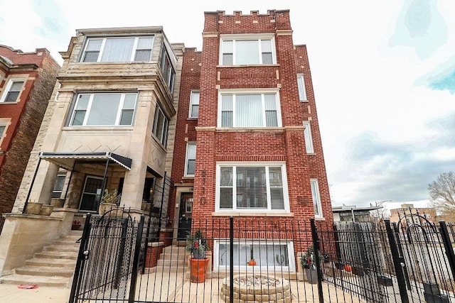 6110 S Saint Lawrence Ave, Chicago, IL 60637 - multi unit property featuring a fenced front yard, brick siding, a gate, and stone siding
