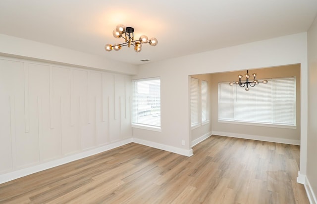 6110 S Saint Lawrence Ave, Chicago, IL 60637 - unfurnished dining area with a chandelier, light wood-type flooring, and baseboards