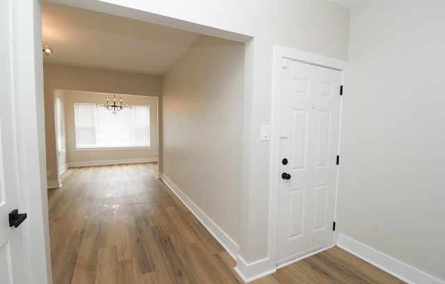 6110 S Saint Lawrence Ave, Chicago, IL 60637 - hall with wood finished floors, a chandelier, and baseboards