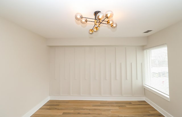 6110 S Saint Lawrence Ave, Chicago, IL 60637 - empty room with a chandelier, light wood-style floors, and baseboards