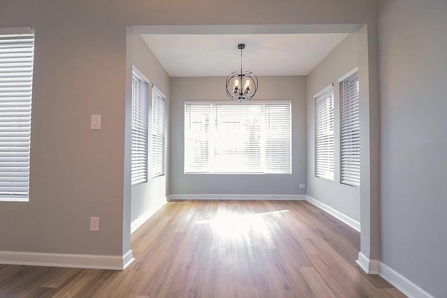 6110 S Saint Lawrence Ave, Chicago, IL 60637 - unfurnished dining area featuring a chandelier, wood finished floors, and baseboards