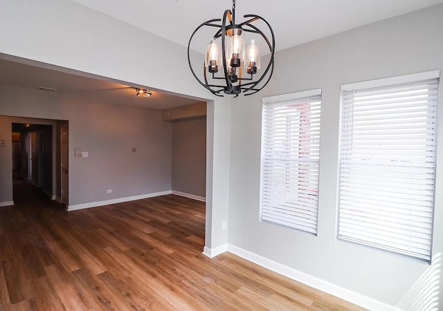 6110 S Saint Lawrence Ave, Chicago, IL 60637 - empty room featuring a chandelier, wood finished floors, and baseboards