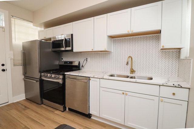 6110 S Saint Lawrence Ave, Chicago, IL 60637 - kitchen featuring stainless steel appliances, a sink, backsplash, and white cabinets