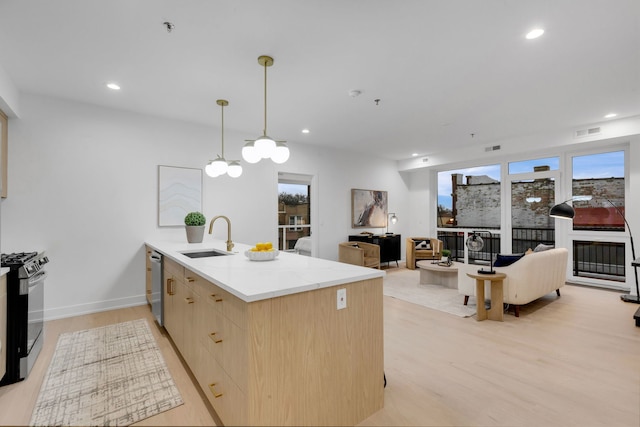 3204 N Kostner Ave Unit 307, Chicago, IL 60618 - kitchen featuring a sink, range with gas cooktop, stainless steel dishwasher, light brown cabinets, and light wood-style floors