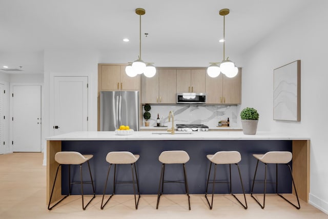 3204 N Kostner Ave Unit 307, Chicago, IL 60618 - kitchen featuring stainless steel appliances, a kitchen breakfast bar, tasteful backsplash, recessed lighting, and a sink