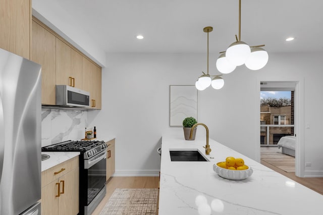 3204 N Kostner Ave Unit 307, Chicago, IL 60618 - kitchen with stainless steel appliances, a sink, light brown cabinetry, light stone counters, and recessed lighting