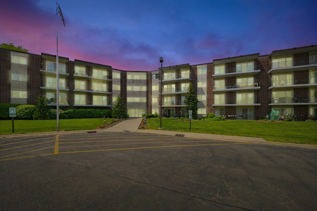 5540 Walnut Ave Unit 26C, Downers Grove, IL 60515 - property at dusk featuring a view of apartment building / complex and uncovered parking