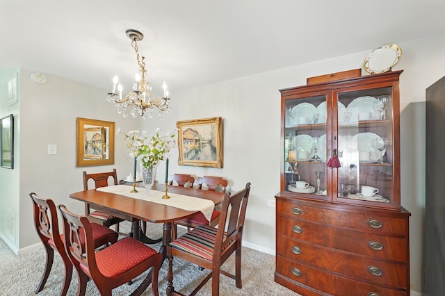 5540 Walnut Ave Unit 26C, Downers Grove, IL 60515 - dining space featuring light carpet, a chandelier, and baseboards