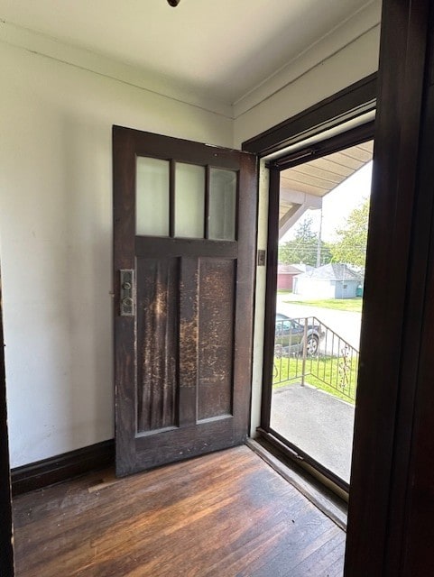 301 S Hebbard St, Joliet, IL 60433 - doorway to outside featuring dark wood-style floors, crown molding, and baseboards