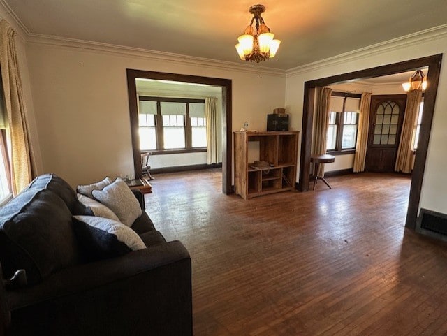 301 S Hebbard St, Joliet, IL 60433 - living area with healthy amount of natural light, ornamental molding, a chandelier, and wood finished floors