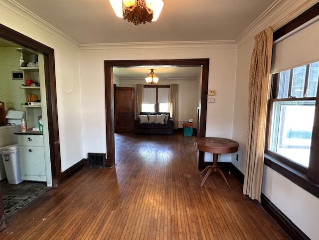 301 S Hebbard St, Joliet, IL 60433 - corridor with a chandelier, plenty of natural light, dark wood-type flooring, and crown molding
