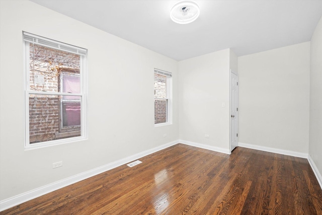 8214 S Paxton Ave, Chicago, IL 60617 - spare room with dark wood-type flooring and baseboards