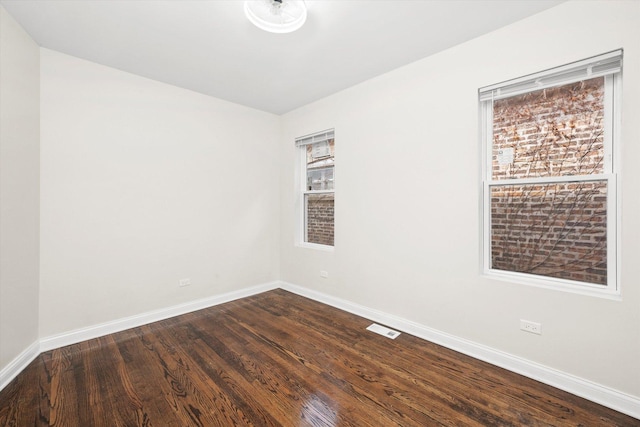 8214 S Paxton Ave, Chicago, IL 60617 - empty room featuring dark wood finished floors and baseboards