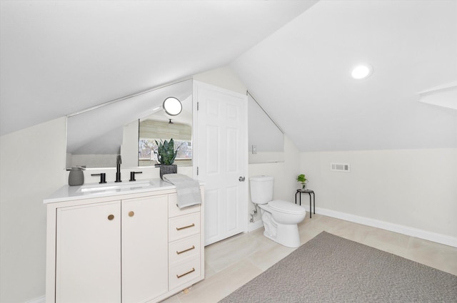 8214 S Paxton Ave, Chicago, IL 60617 - bathroom featuring toilet, lofted ceiling, vanity, baseboards, and tile patterned flooring
