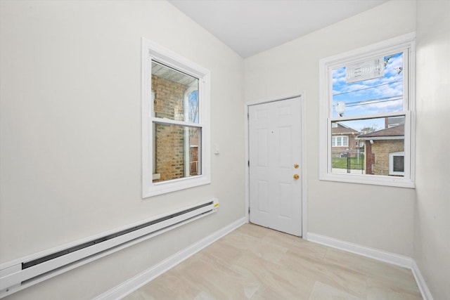 8214 S Paxton Ave, Chicago, IL 60617 - doorway to outside with a baseboard heating unit and baseboards